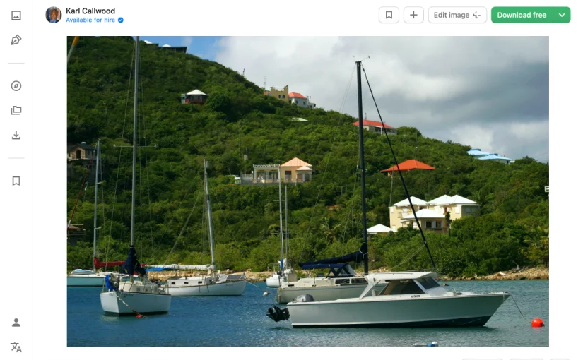 Caribbean marina with sailboats anchored in turquoise waters, surrounded by lush green hills and colorful waterfront homes — a scene that captures Sint Maarten's vibrant maritime character